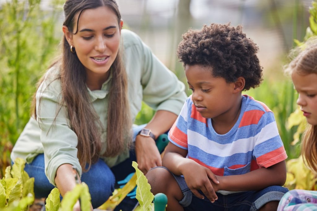 Cropped Shot Of An Attractive Young Woman And Two Adorable Little Kids Working On A Farm