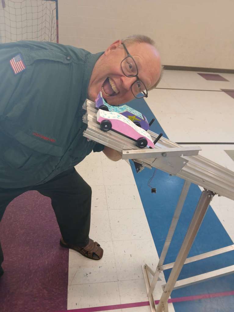 Boy Scout leader preparing to start a race